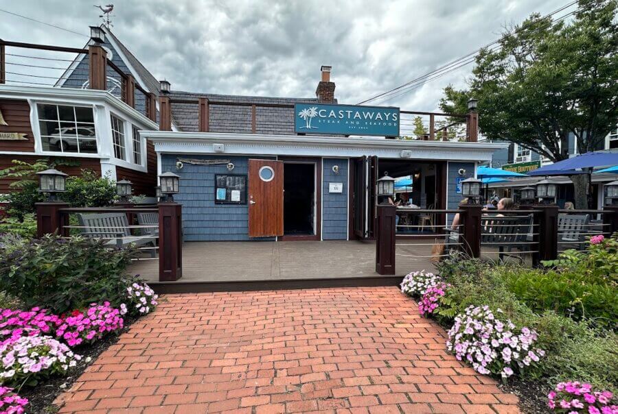 Exterior view of restaturant with people sitting on benches